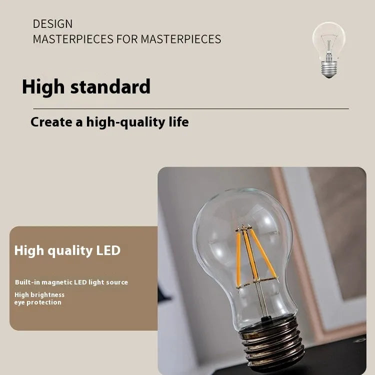 Creative iron art suspension bulb night lamp on a black wood grain desk base