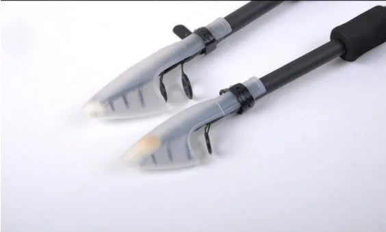 Telescopic carbon fishing rod with matte coating and reel seat on a lakeside bank