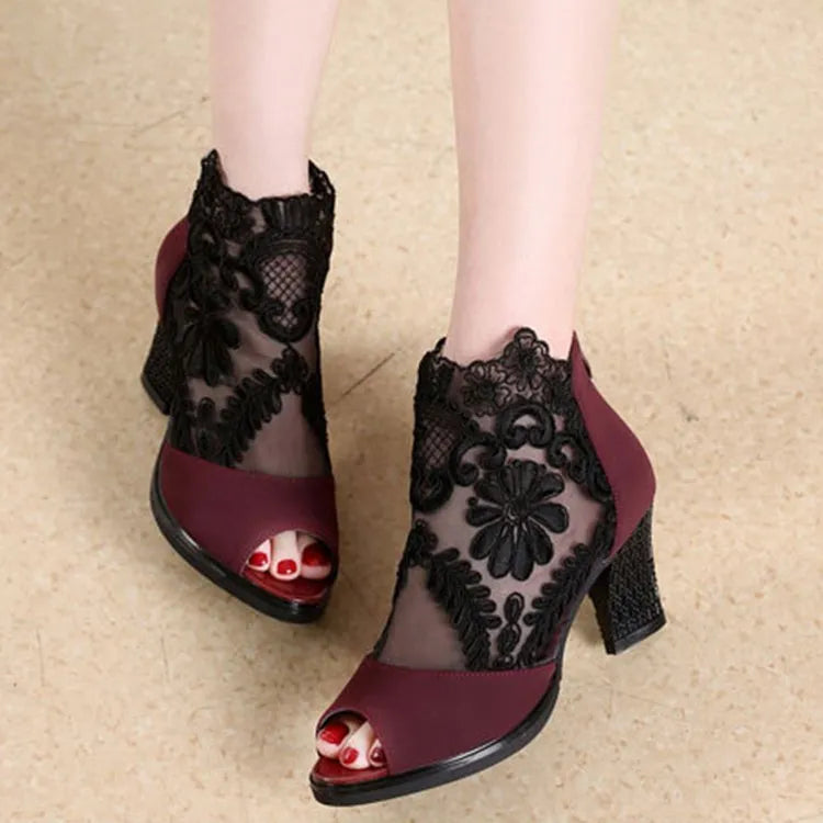 Women's black lace gladiator sandals with a square high heel and peep toe, showing zip closure