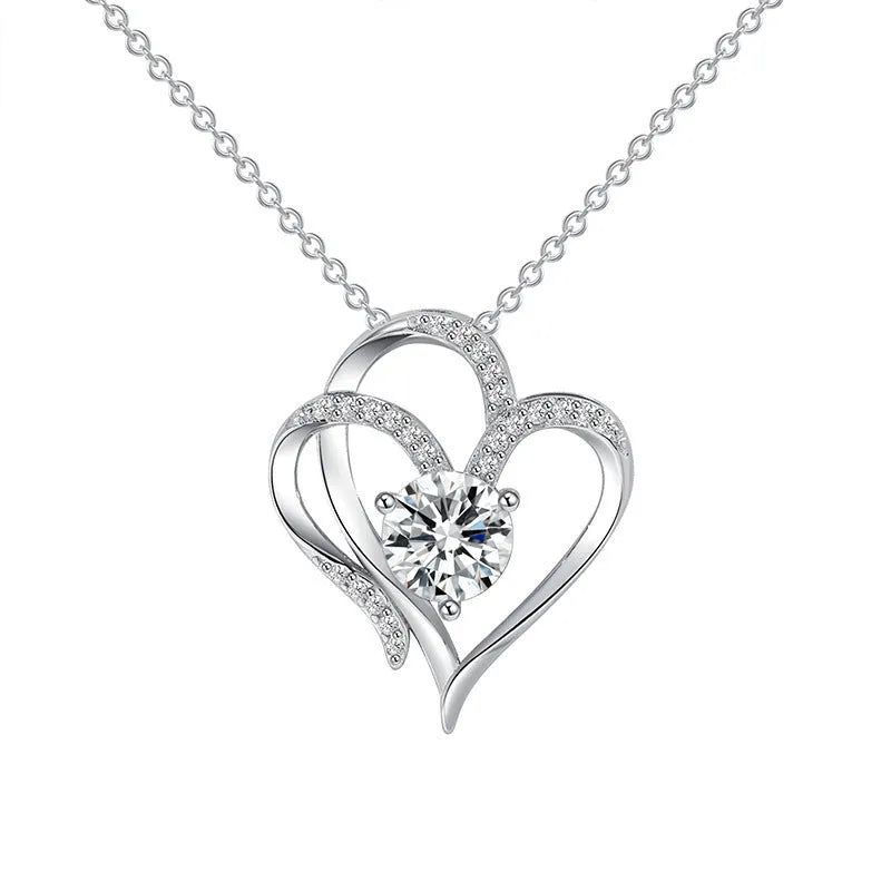 Women's heart-shaped 925 silver necklace with diamond-cut treatment on a model.