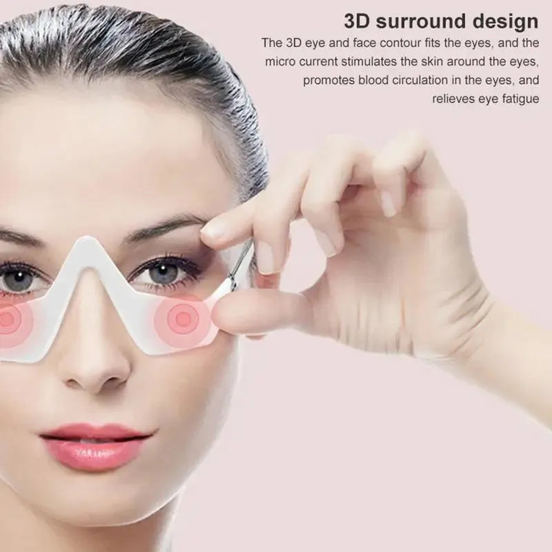Pink and white micro-current eye massager with glasses-style design on a stand.