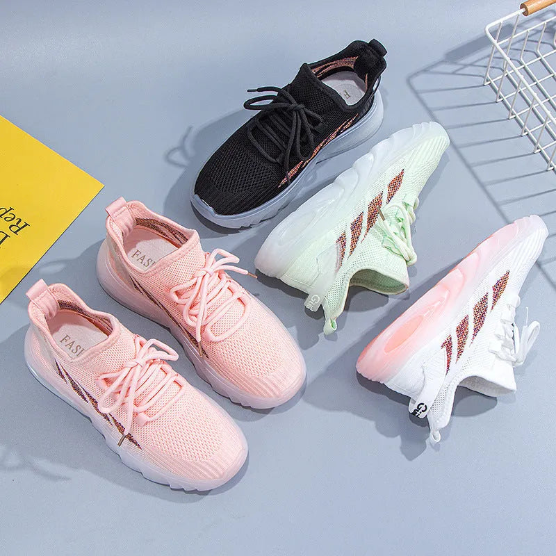 Women's white cowhide sports casual shoes with flat plastic sole and high ankle opening on a wooden floor.