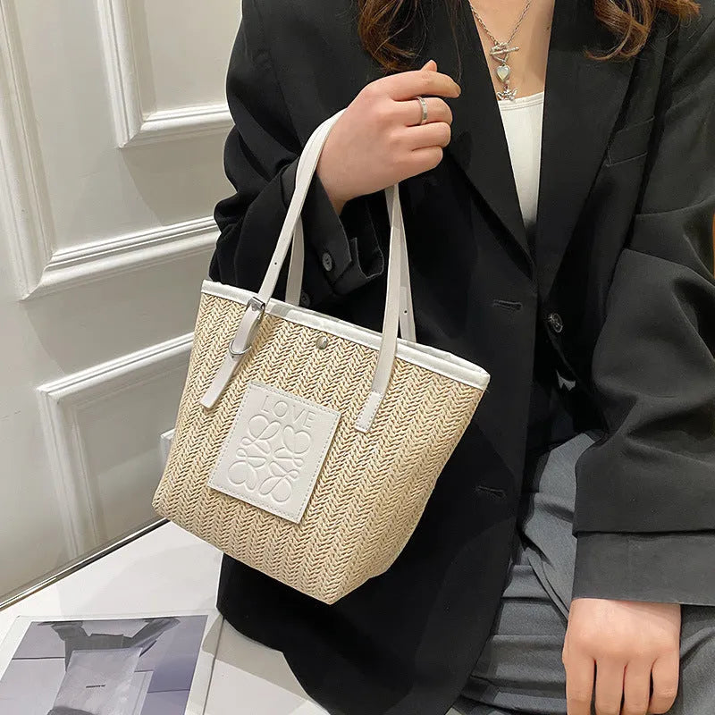 Women's woven straw shoulder bag with large capacity showing European retro styling and three-dimensional pocket