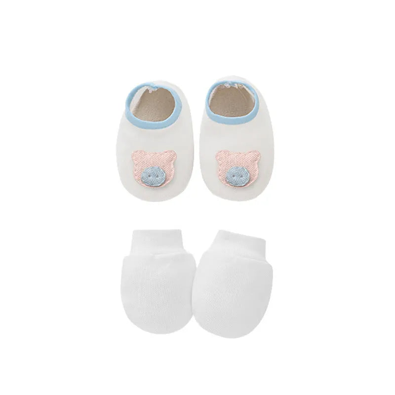 Set of white, light blue, and grey cotton baby pullover caps, gloves, and foot covers for infants.