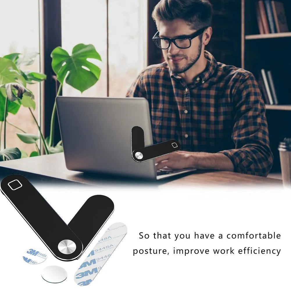 Black aluminium laptop phone holder with magnetic mount attached to side of silver laptop