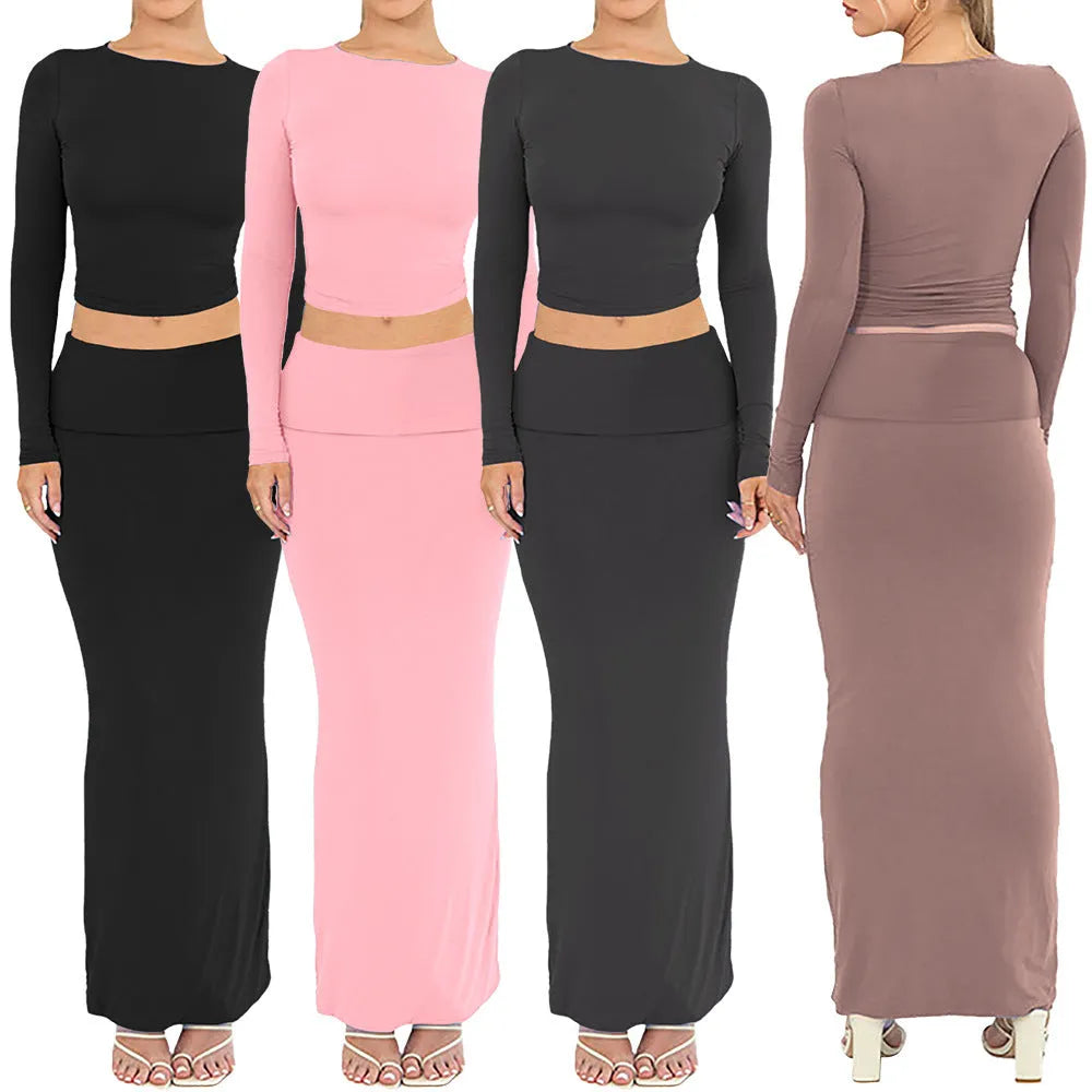 Women's black slim fit two-piece suit with exposed navel top and long skirt.