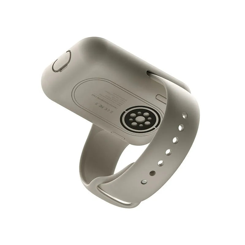 Portable wireless power bank charging case for Apple Watch in silicone case, shown next to watch.