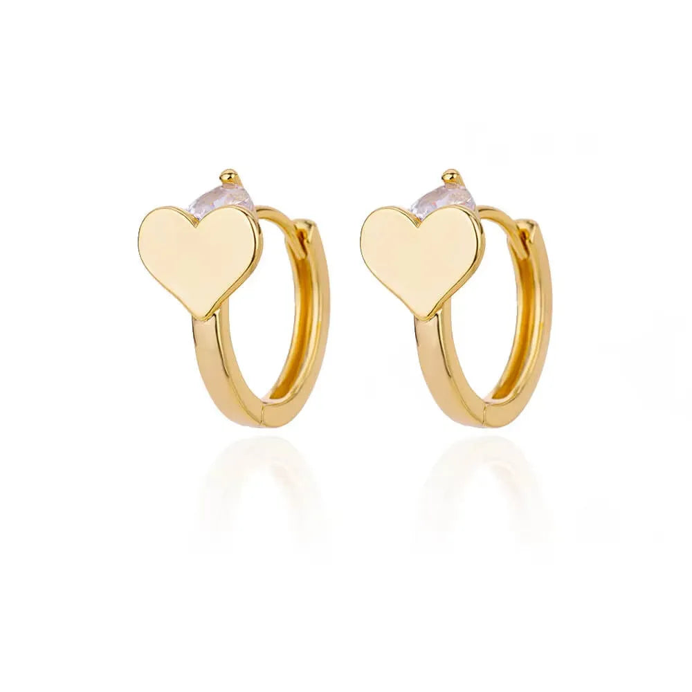 A pair of gold tone heart-shaped stud earrings for women with a simple zircon love design.