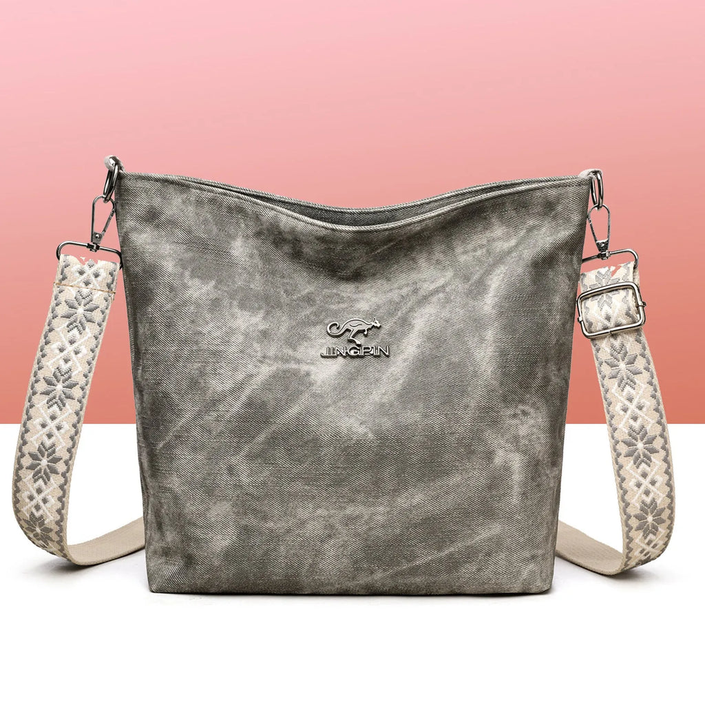 Soft grey PU crossbody bag with adjustable strap on mannequin