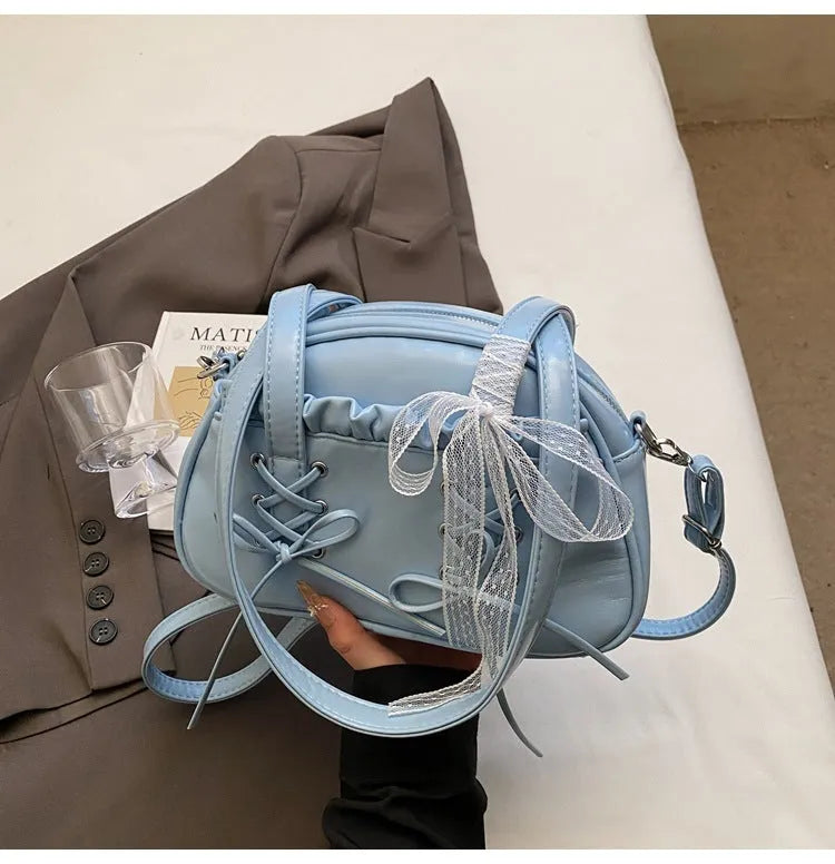 Women's casual PU leather shoulder bag with a bandage bow design and internal phone compartment.