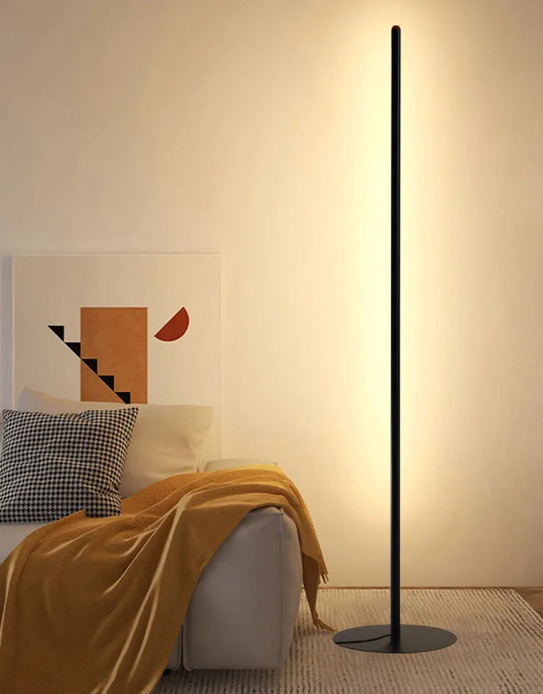 Vertical aluminium alloy floor lamp in modern simple style placed beside a sofa.