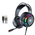 Black wired gaming headset with microphone, adjustable headband, and large circular ear cups on a desk.