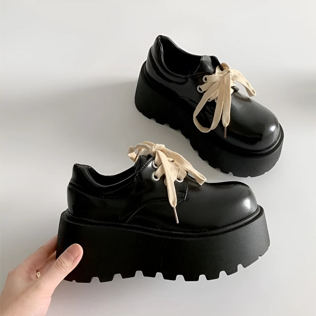 Matte black women's lace-up high-heeled shoes with a thick rubber sole and English muffin heel.