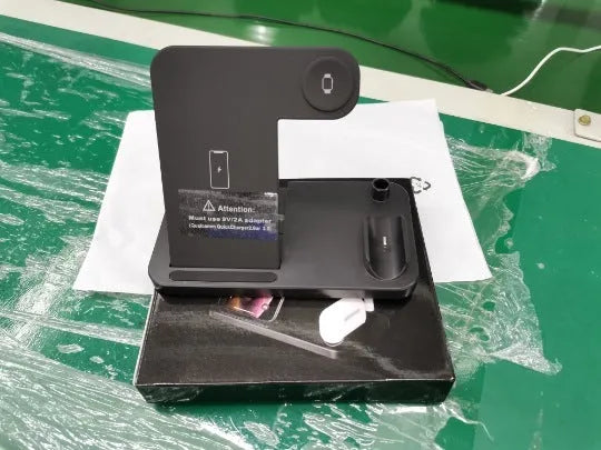 Folding 4-in-1 wireless charger in space grey, charging an iPhone, Apple Watch, and Apple Pencil.
