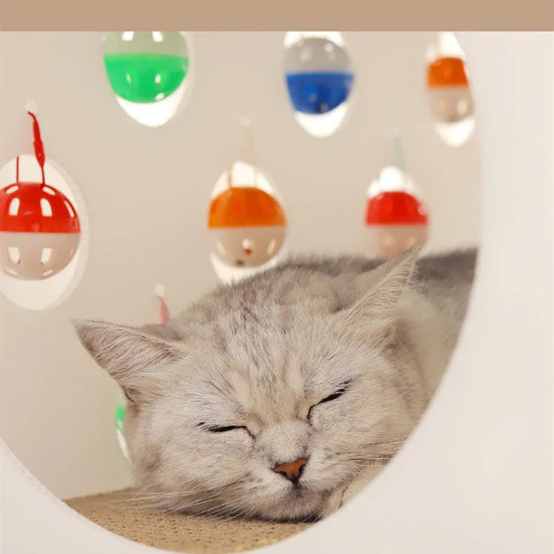 White plastic cat scratch board with integrated round nest bed and short tunnel with dangling bell ball