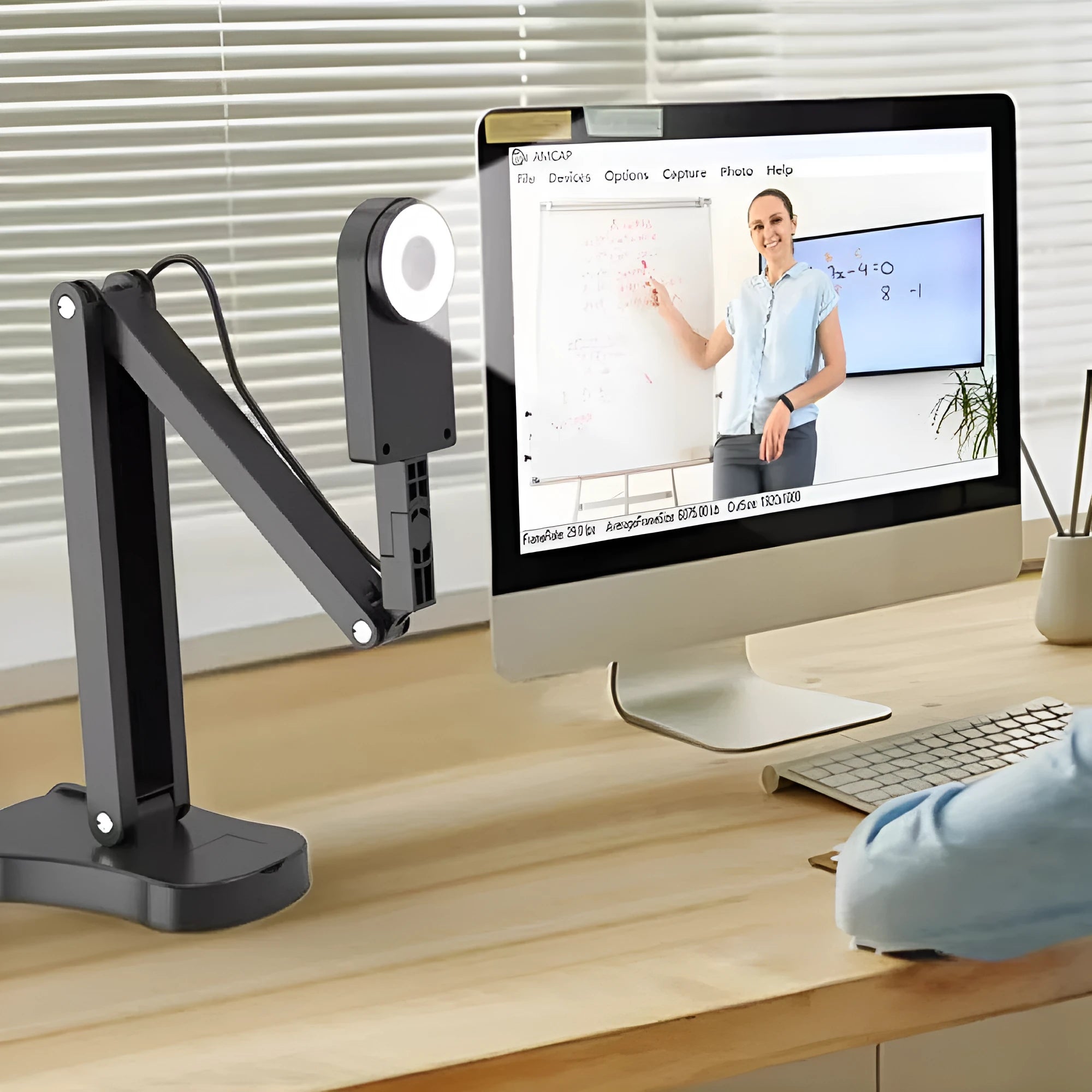 Computer webcam with microphone showing USB cable connection and compact design