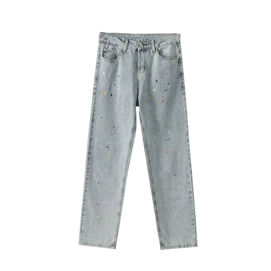 Light blue straight loose jeans with paint splash and washed finish, mid-waist zip fly, laid flat on neutral background
