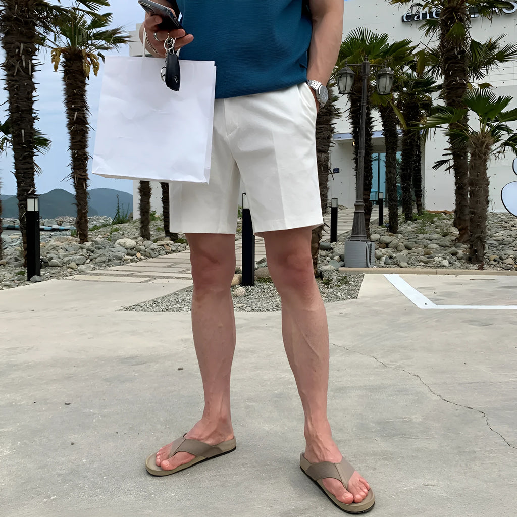 Men's straight-leg polyester shorts in solid black colour showing loose casual fit