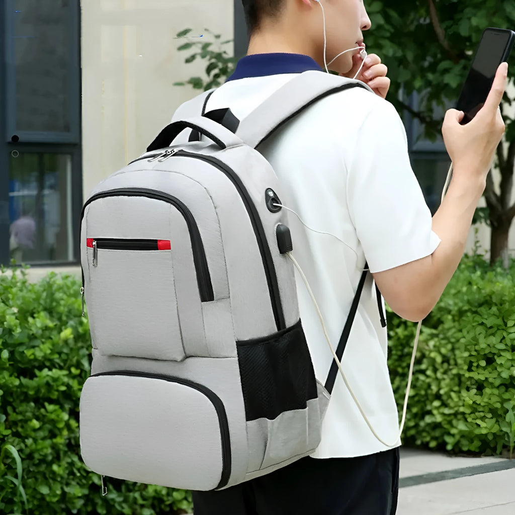 Light grey insulated Oxford cloth backpack with curved shoulder straps, shown with its pull rod belt accessory.
