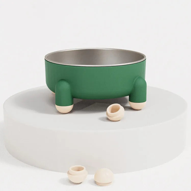 Green stainless steel pet bowl with non-slip base and raised high foot on a wooden floor.