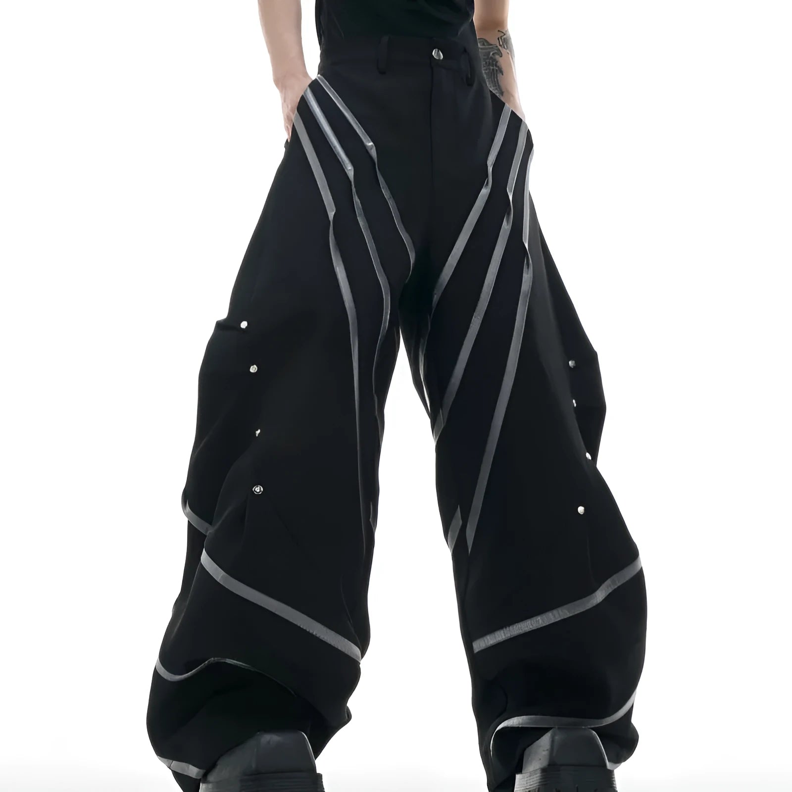 Men's black and white polyester trousers with 3D cutting, metal rivet stripes, and pleated front.