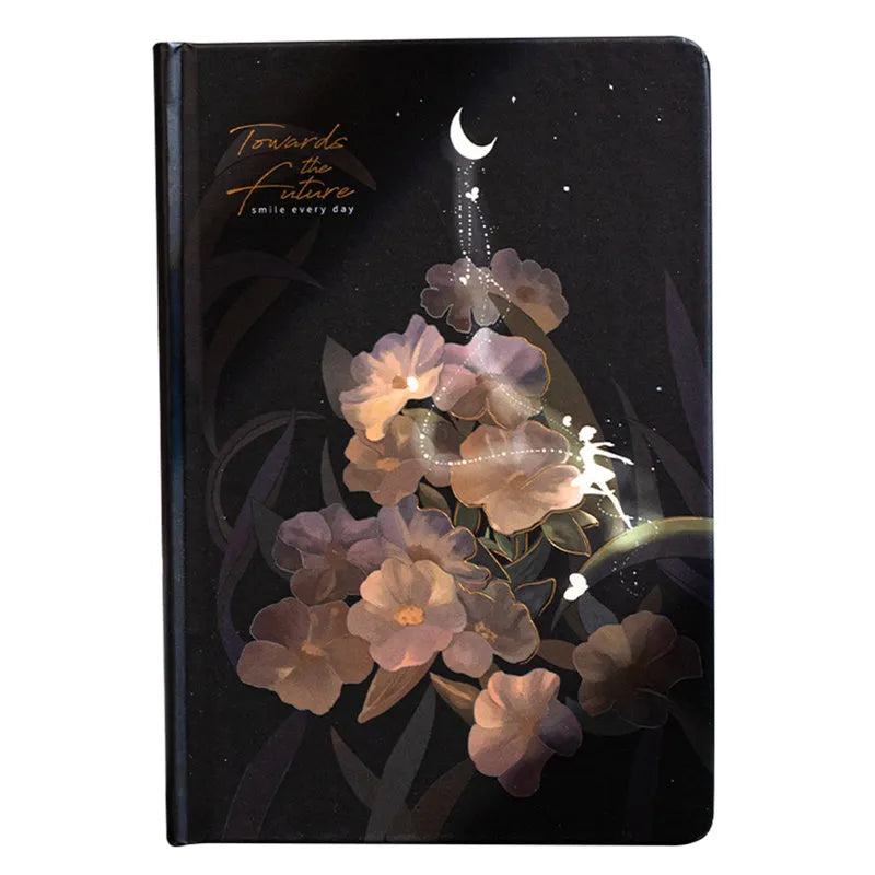 A5 notebook with a luminous cover shown in deep blue, open to reveal pages with colour illustrations.