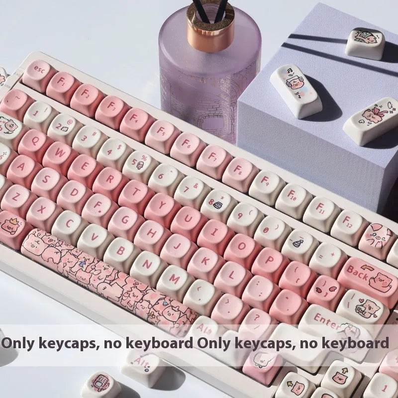 Set of pastel pink PBT key caps with a fragrant pig design, shown with a key puller tool.