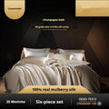 Silk four-piece bedding set in a solid colour, showing quilt cover and pillowcases on a bed.