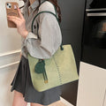 Green urban minimalist PU shoulder bag with stitching detail and double straps on a white background.