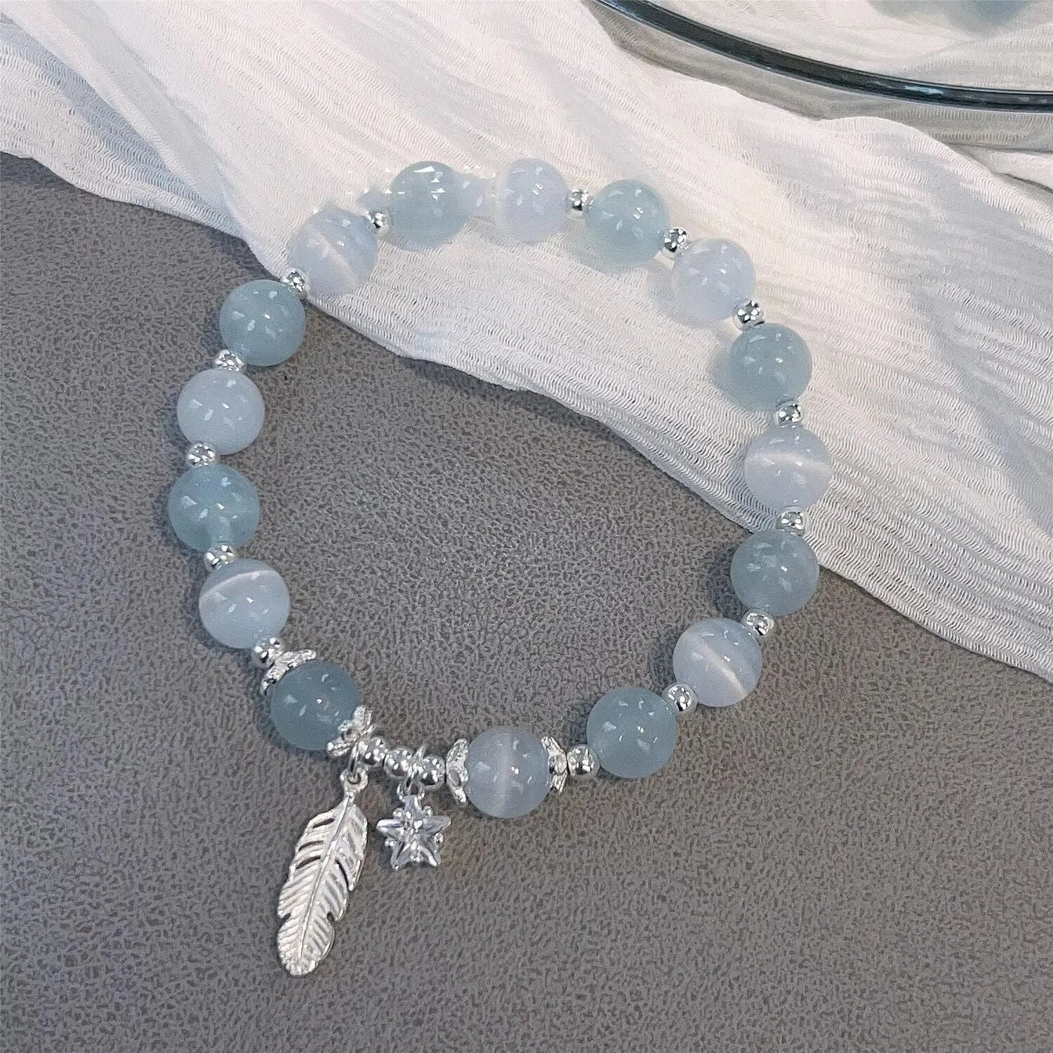 Small white crystal bracelet with blue moonlight colour and star design, Korean-style glass jewellery.