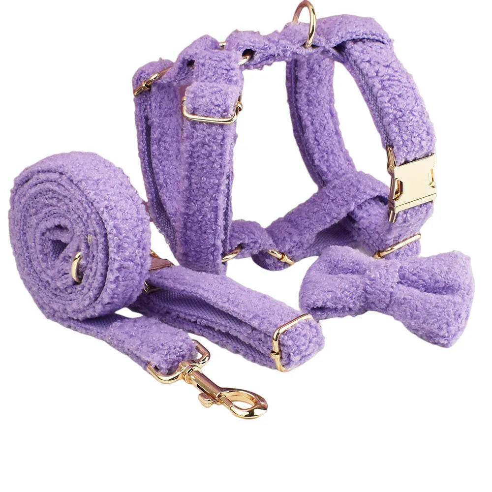 Purple cloth dog accessory set showing collar, leash, bow, and vest for small dogs
