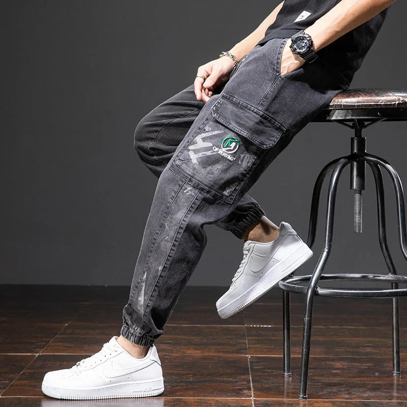 A pair of men's loose-fit cargo jeans in a blue colour, showing the straight leg and casual style.