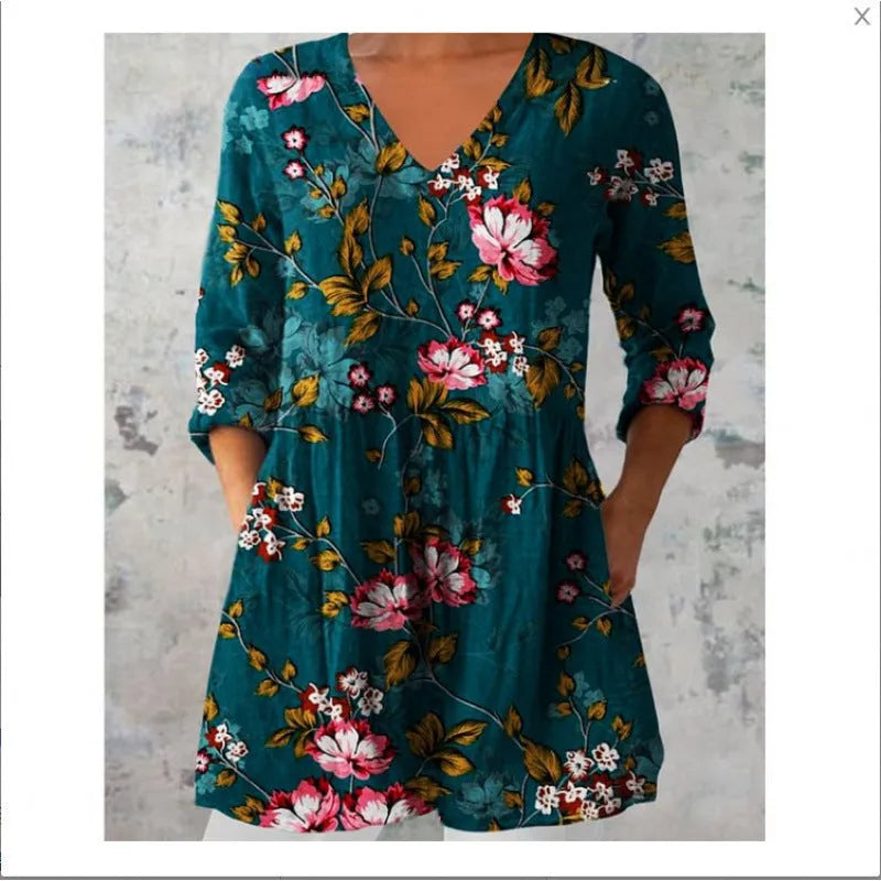 A woman wearing a loose-fitting floral print dress with 3/4 ruffle sleeves and a wide waist.