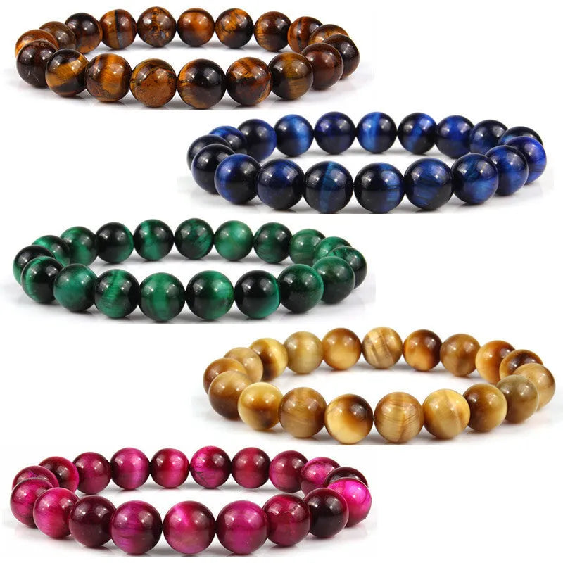 Natural tiger's eye crystal bracelet with round geometric beads in various colours and sizes on a wrist.