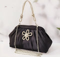 Soft lavender purple women's shoulder messenger bag with chain detail, shown in shell shape with folds.