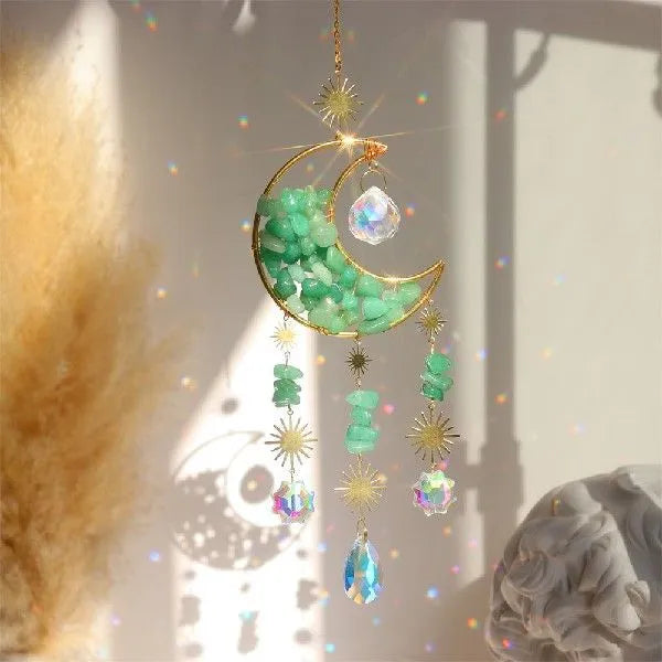Moon-shaped K9 crystal car pendant on a metal base with a hanging chain.