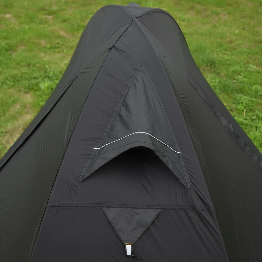 Single person green tunnel tent with aluminium poles pitched in a forest, showing mesh door and waterproof flysheet.