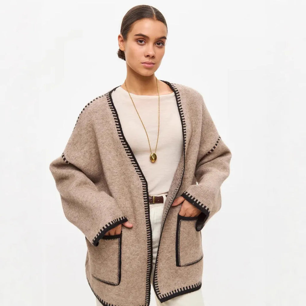 Loose fit lace-up knitted cardigan in black, shown as a mid-length sweater coat.