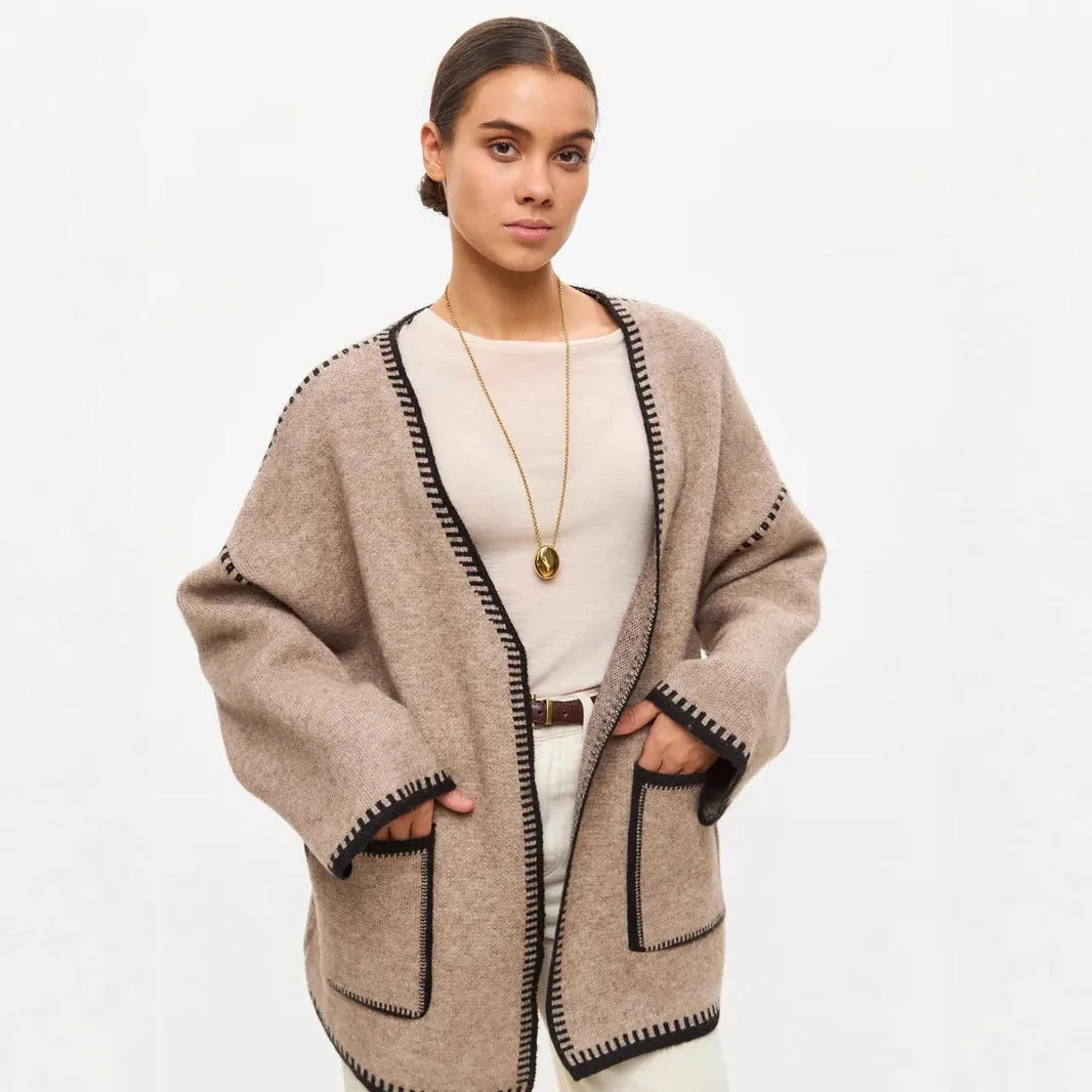 Loose fit lace-up knitted cardigan in black, shown as a mid-length sweater coat.