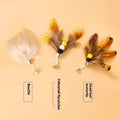 Three steel wire cat toy replacement heads in small flying insect designs on a white background.
