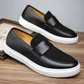 Men's black slip-on casual shoes with tassel detail and round toe