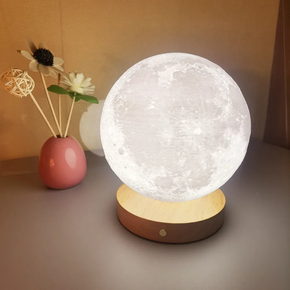 Rotating three-colour moon night lamp with wooden base in Nordic style, showing direct plug connection
