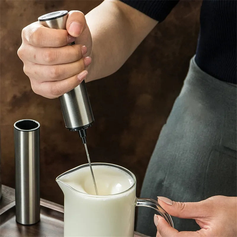 Silver electric milk frother handheld whisk with double stainless steel head on white background