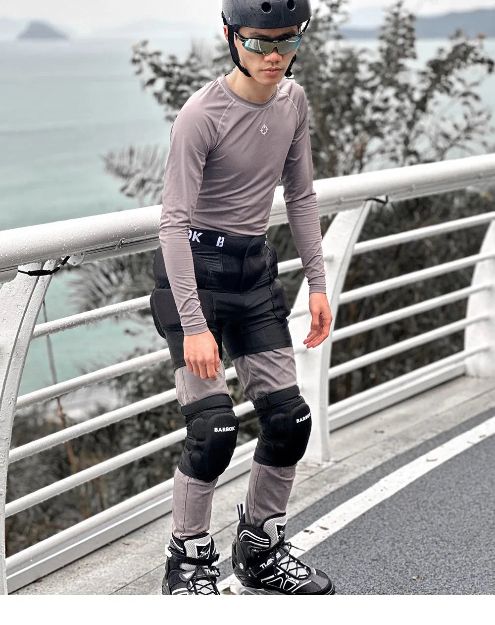 Black adult skating hip protection pad made of spandex and NBR foam on a grey background.
