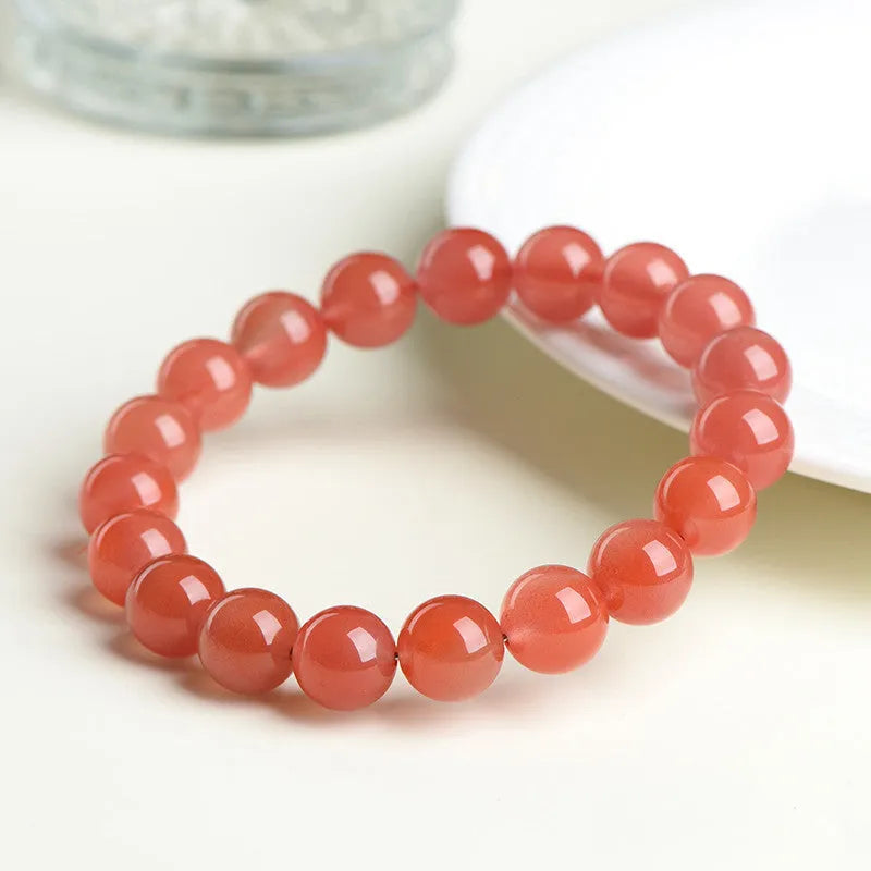 Natural cherry red agate beaded bracelet with high-polish stones on a wrist, showing single and three-strand style options.