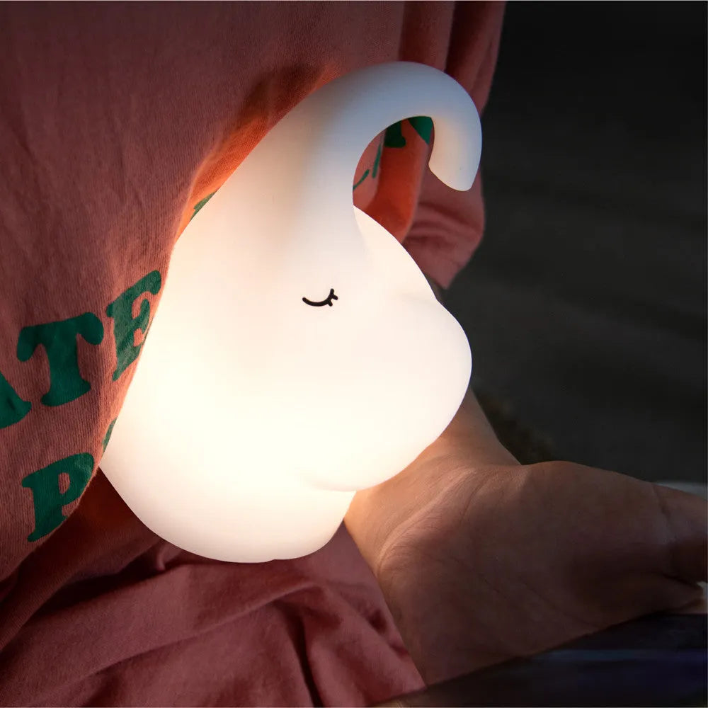 DOMI Elephant silicone night light with warm white glow on a bedside table
