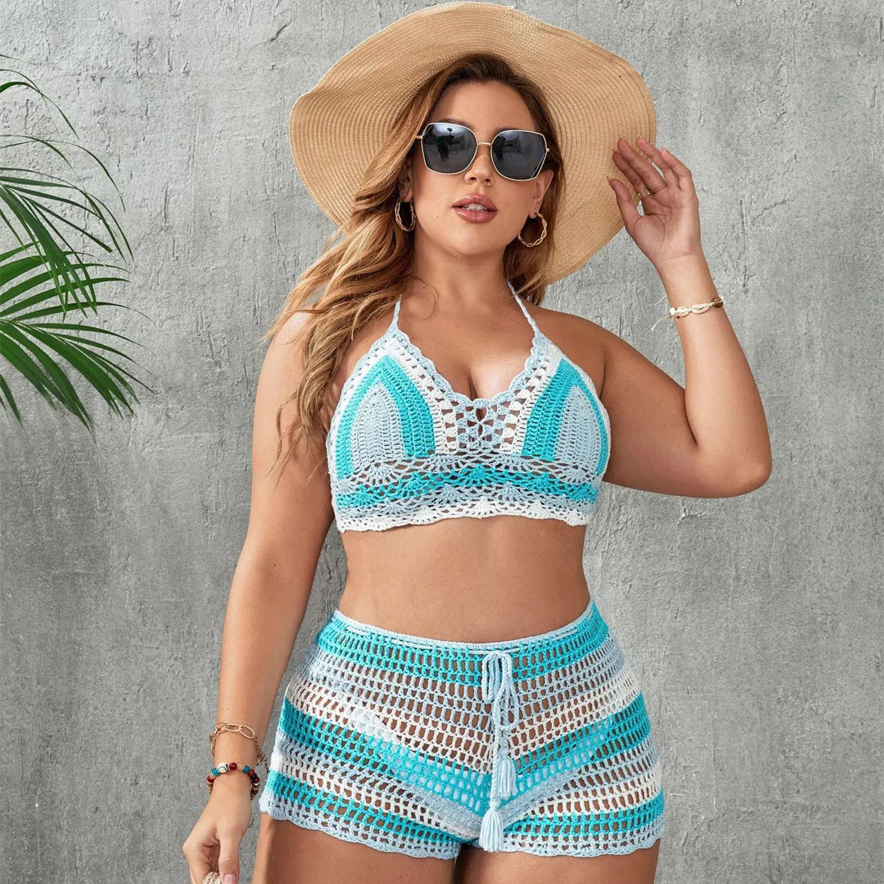 Blue women's brief-style swimsuit with hollow-out strap detail on a mannequin.