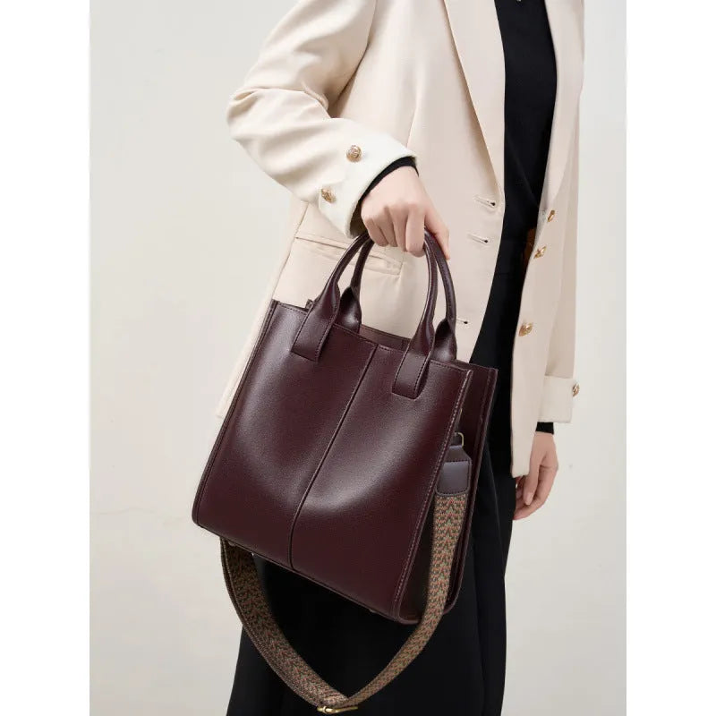 Women's genuine leather shoulder tote bag in black colour showing bucket design and polyester lining
