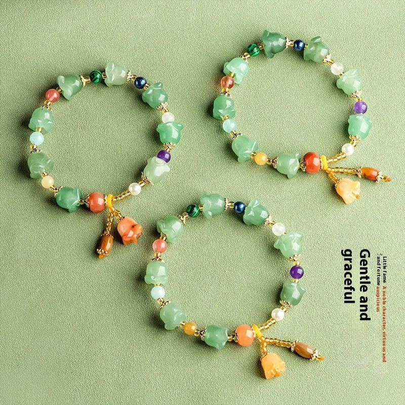 Carved natural Xinjiang Jinsi jade bracelet with aventurine orchid beads and Gobi jade topaz accents.