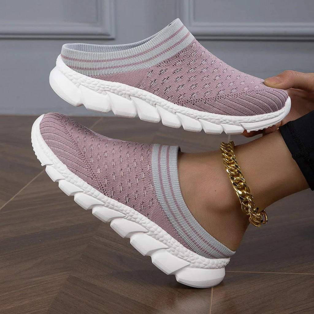 Women's black Flyknit semi-slipper casual shoe with striped pattern and hollow-out design on a white background.